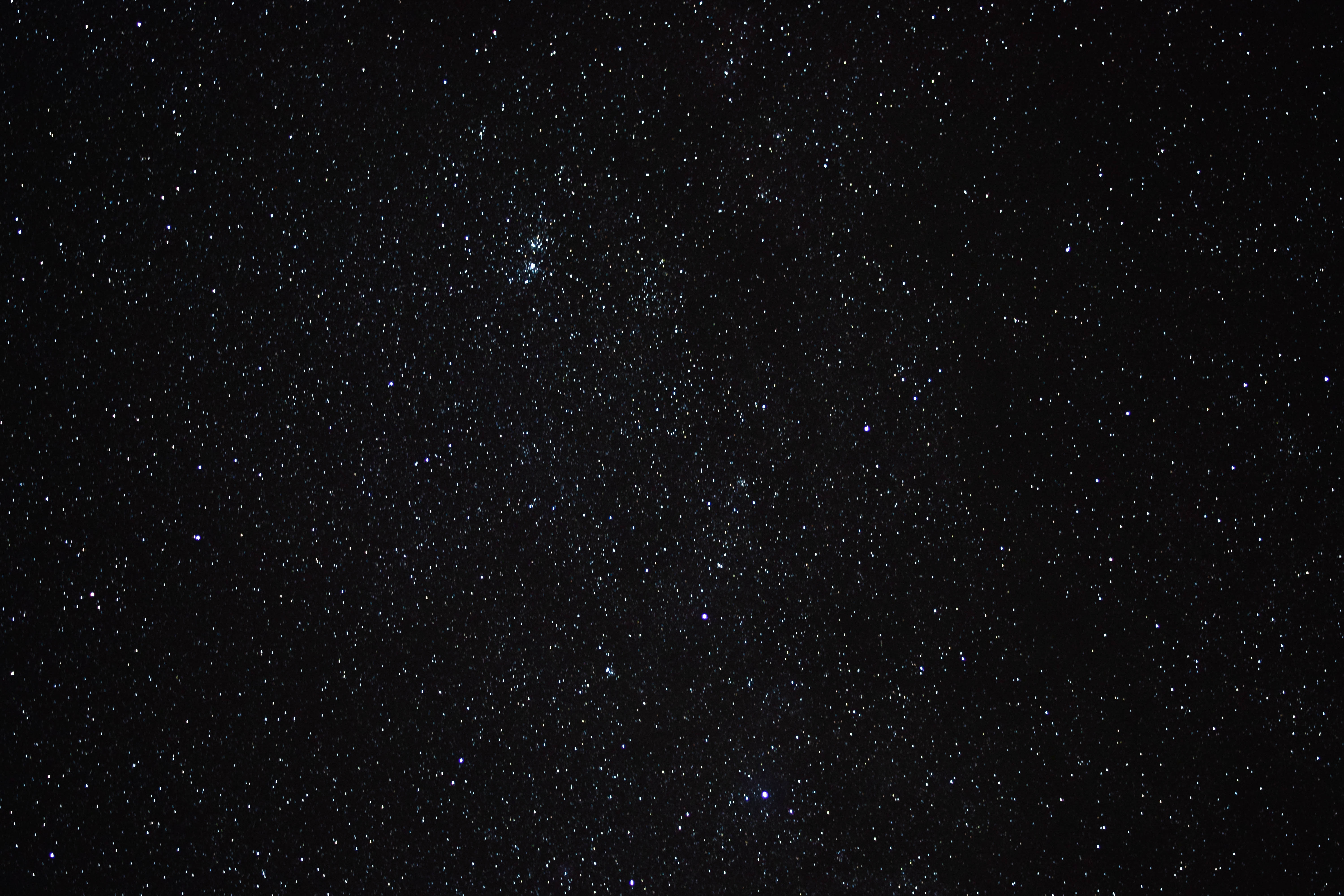 A photo of stars in the night sky, with some stars appearing brighter and larger than others due to post-processing techniques.