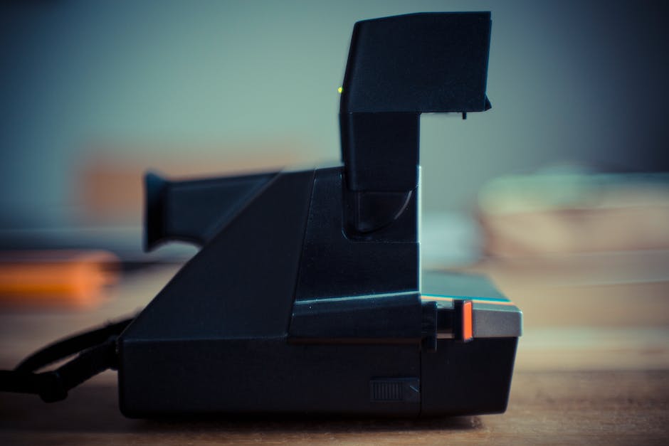 A vintage Polaroid 600 camera, showcasing its iconic design and immediate photo development.