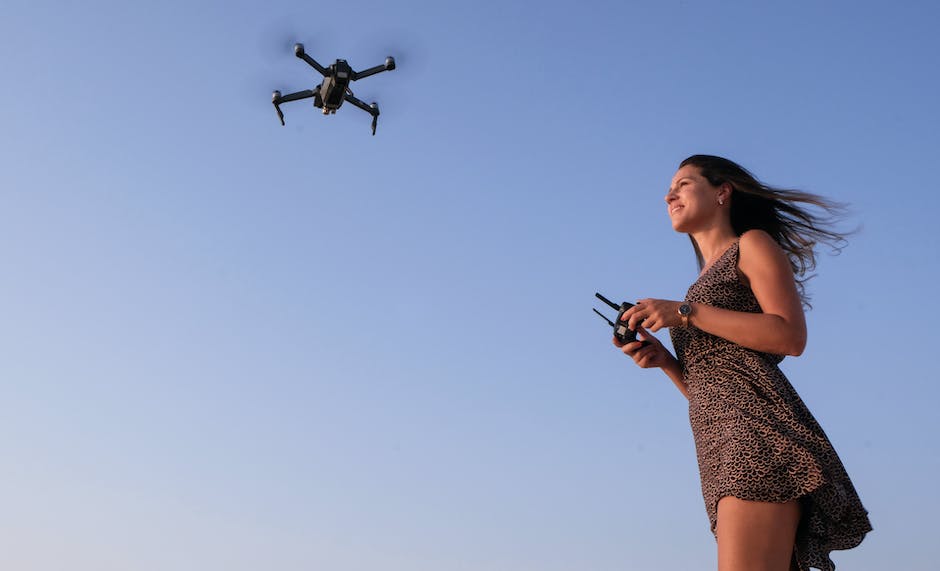 Illustration of a Sharper Image Drone with a person controlling it via a smartphone.