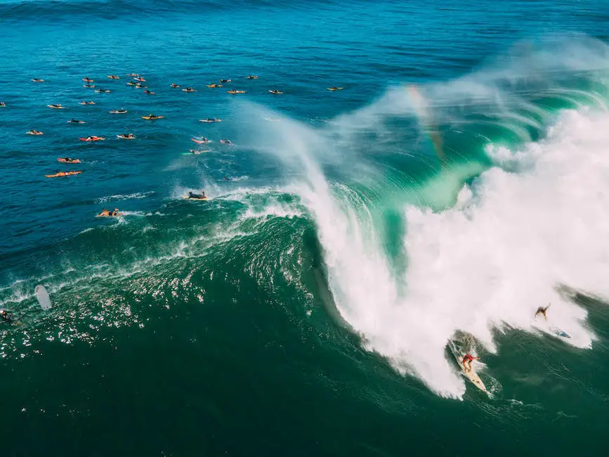 An Aerial photograph of a surfer riding a wave. A stunning view of the ocean from the sky.