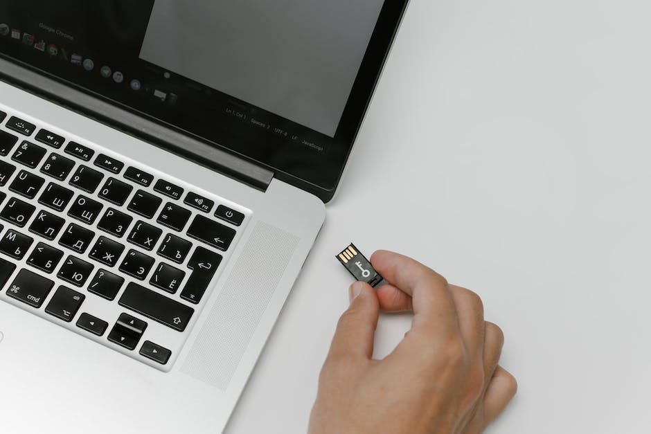 Illustration of a person inserting an SD card into a computer for backup