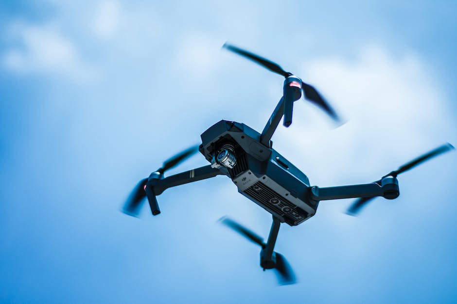 A DJI Phantom series drone flying in the sky.