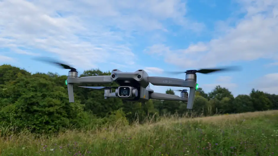 A drone flying over a field with trees in the background, capturing aerial footage.