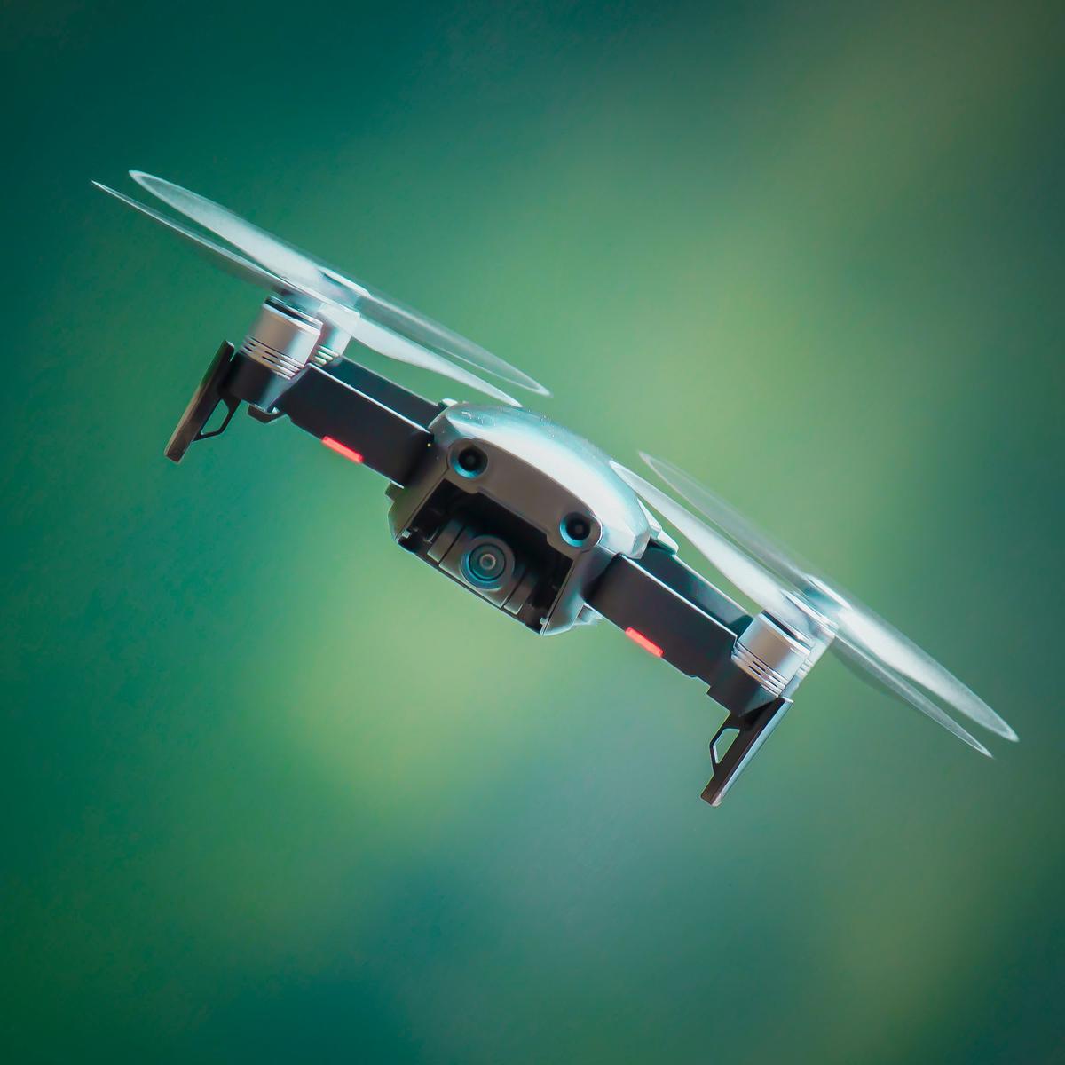 A picture of a drone with a shield around it to signify protection and safety from potential risks and liabilities that come with operating a drone.