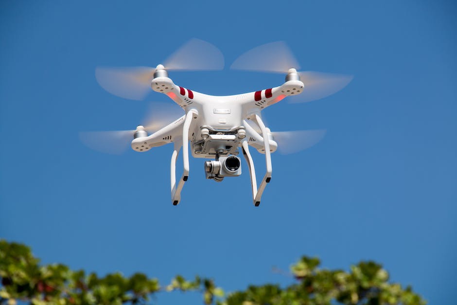 A drone flying in the air with a sky background