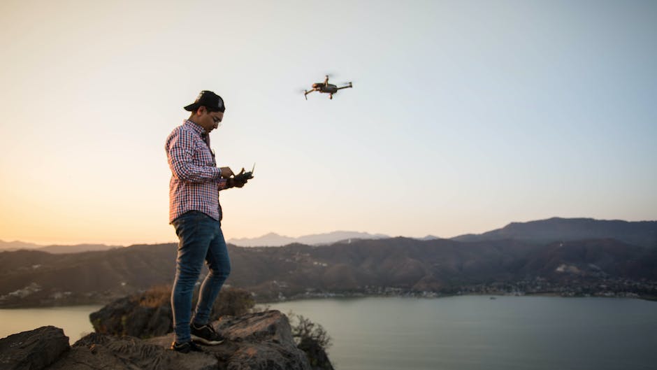 A person flying a FPV drone and a written document of laws and regulations in the background.