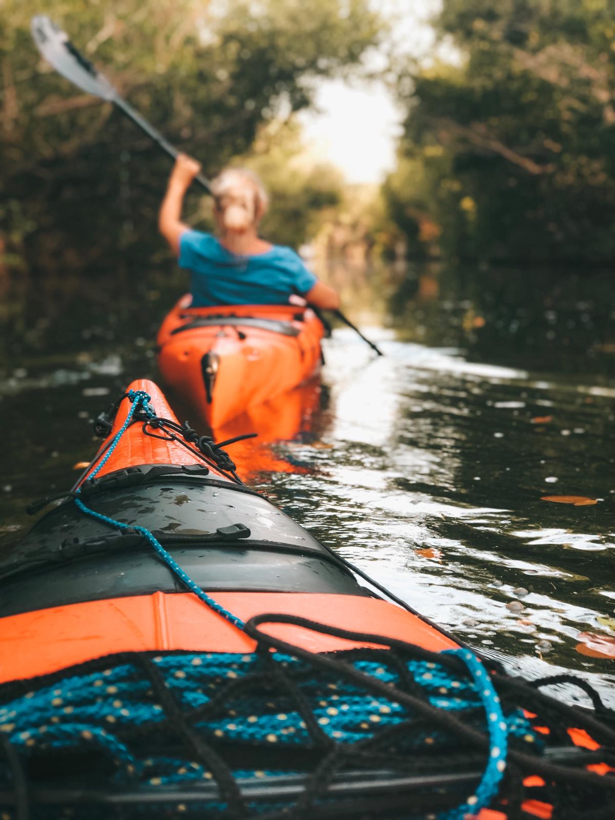 A person kayaking with a GoPro camera mounted on their kayak, capturing stunning footage.