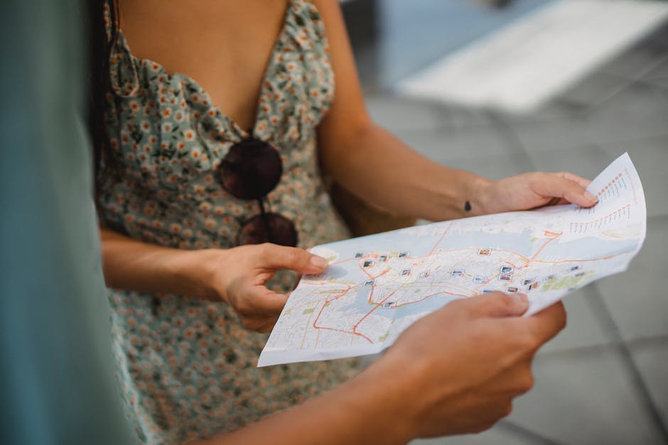Image of a person planning their vlog journey by marking locations on a map