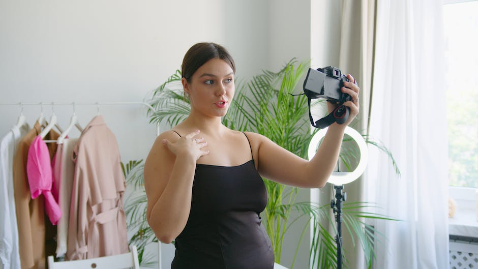 A person holding a camera and recording a vlog, representing the process of vlogging.
