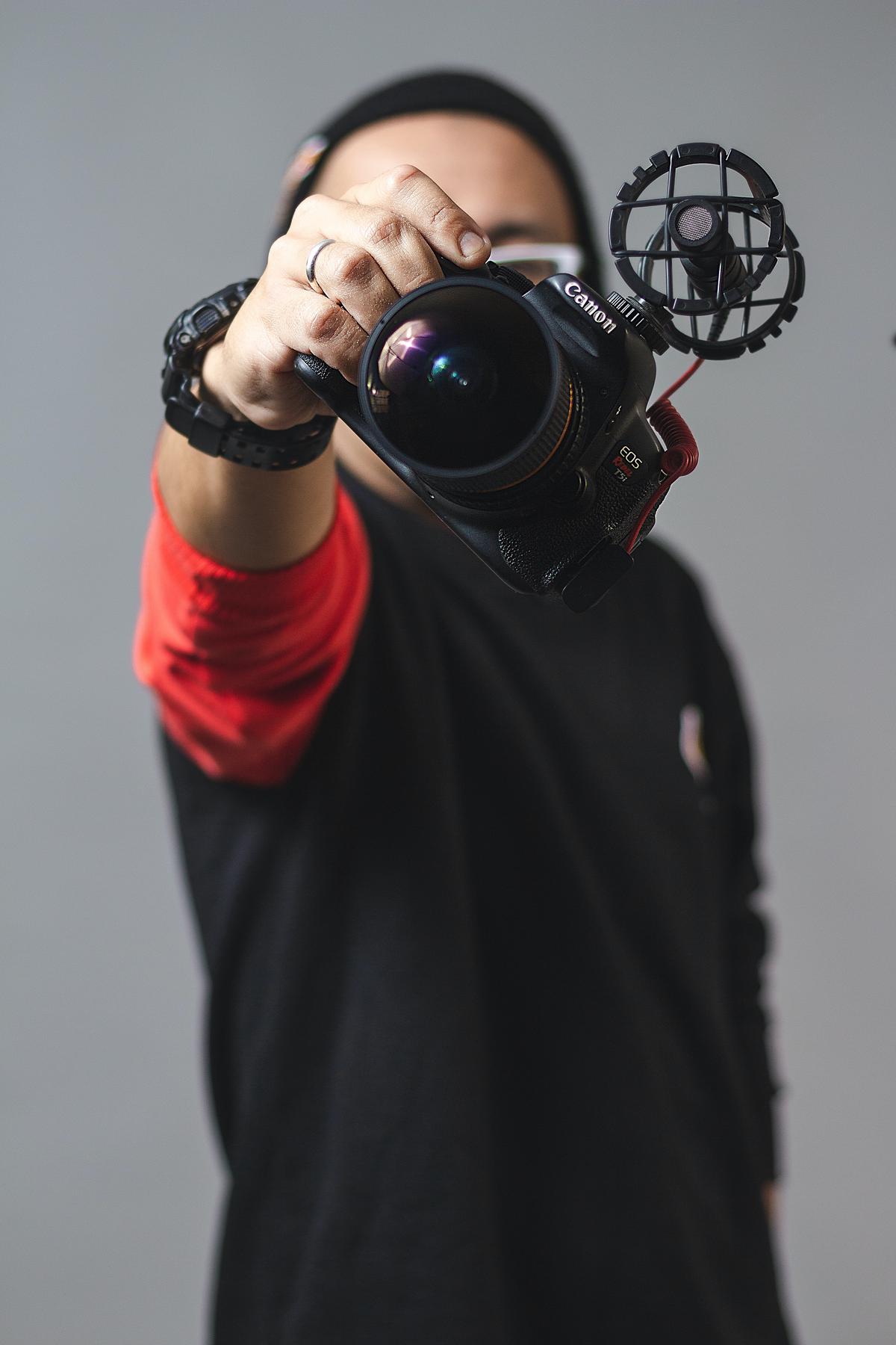 Image of a person holding a camera and planning their vlogging content, symbolizing the process of creating successful vlogs.
